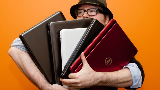 man holding laptops
